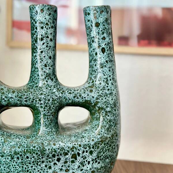 Artisanal vase in black and blue.