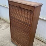 Oak two-column filing cabinet with curtains.