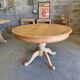 Round cherry table with 2 extensions.