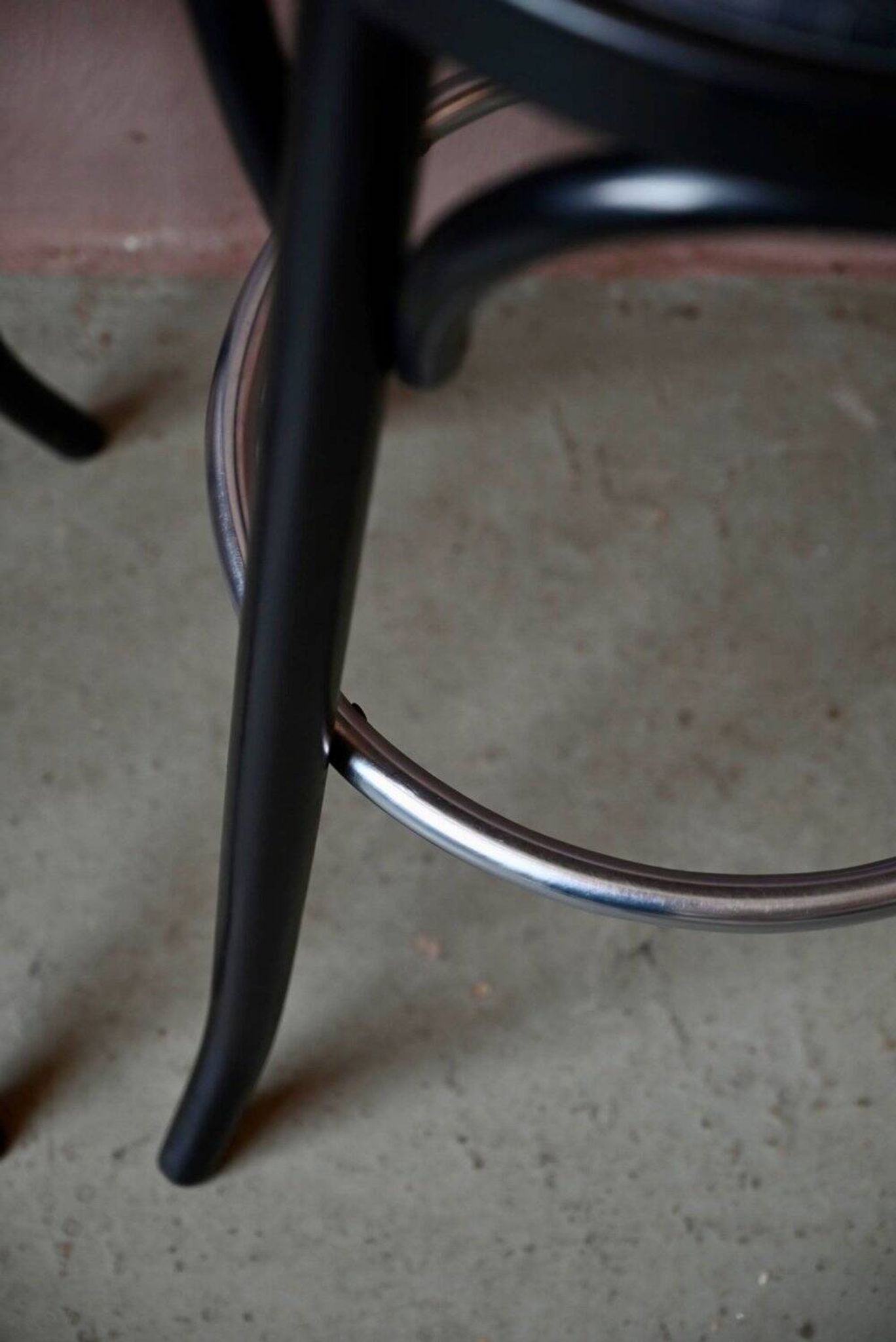 Pair of 1960s bistro bar stools in black and chrome with vinyl shell.
