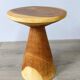 Minimalist side table in solid suar wood with conical legs.
