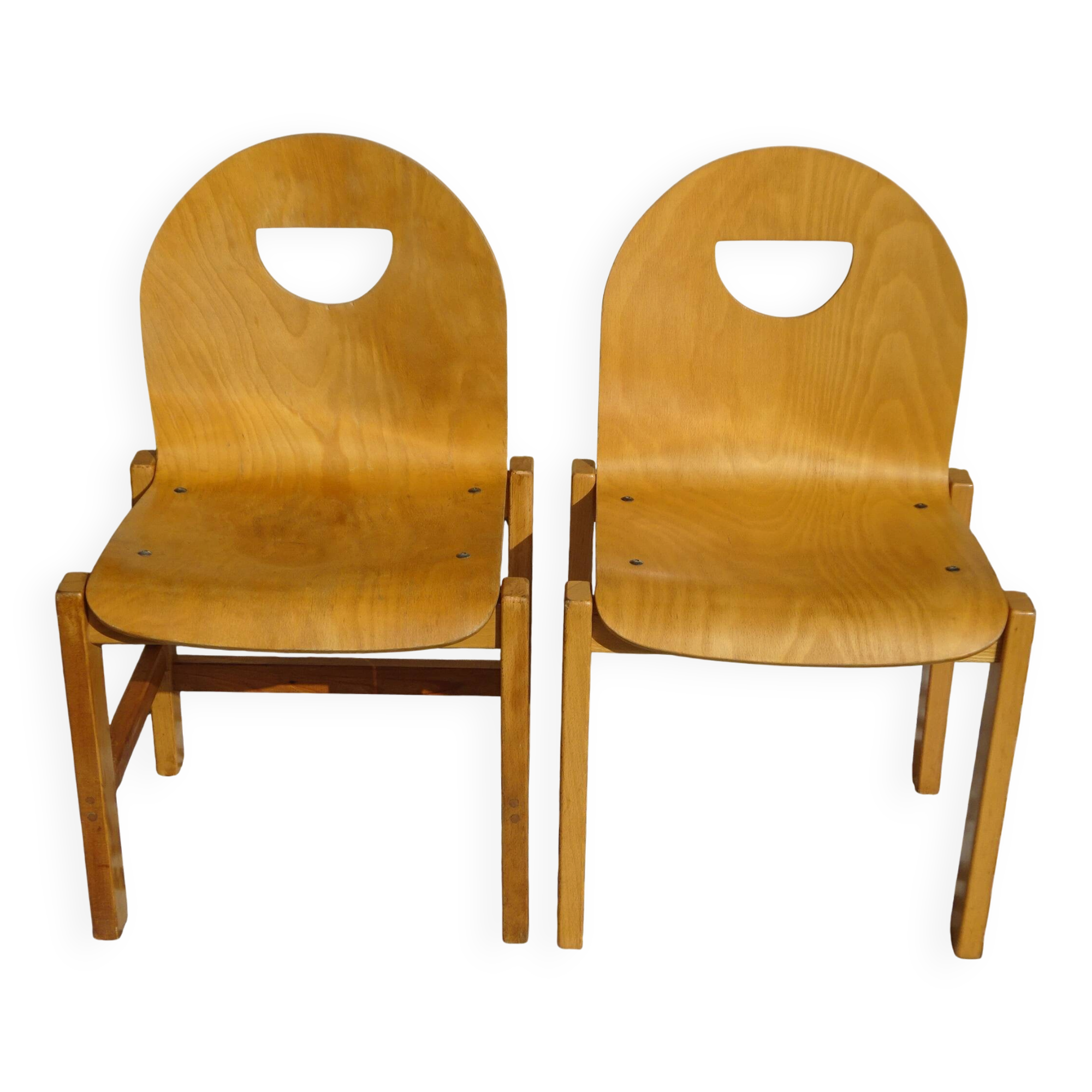 Pair of light wood chairs with post-formed seat and backrest.