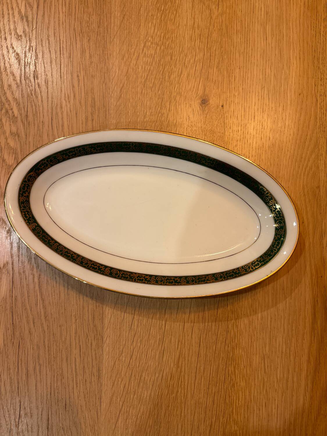 Complete old service in green and gold Limoges porcelain.