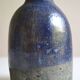 Ceramic bottle vase with a fish signature to be identified.