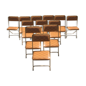 Set of 12 vintage folding chairs in Skaï seats and quilted backrests with golden tubular base