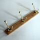 Wall mounted wooden coat rack with 3 brass hooks, vintage from the 50s