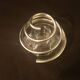 Round glass candle holder with silver-plated metal spiral.