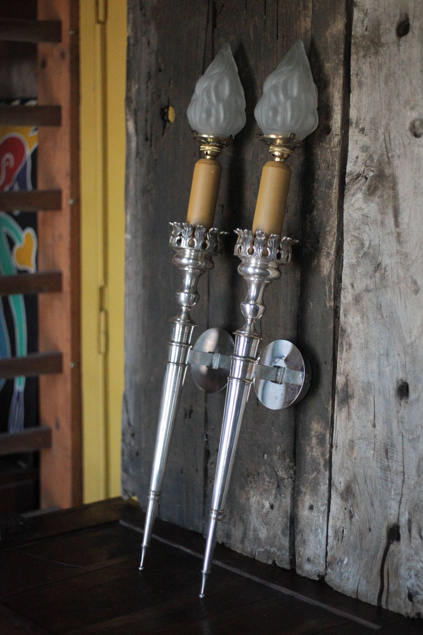 Large pair of silver-plated wall lights with flame globes, torches.