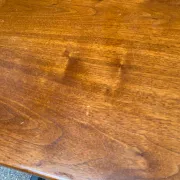 Small Scandinavian-style computer desk on wheels made of wood.