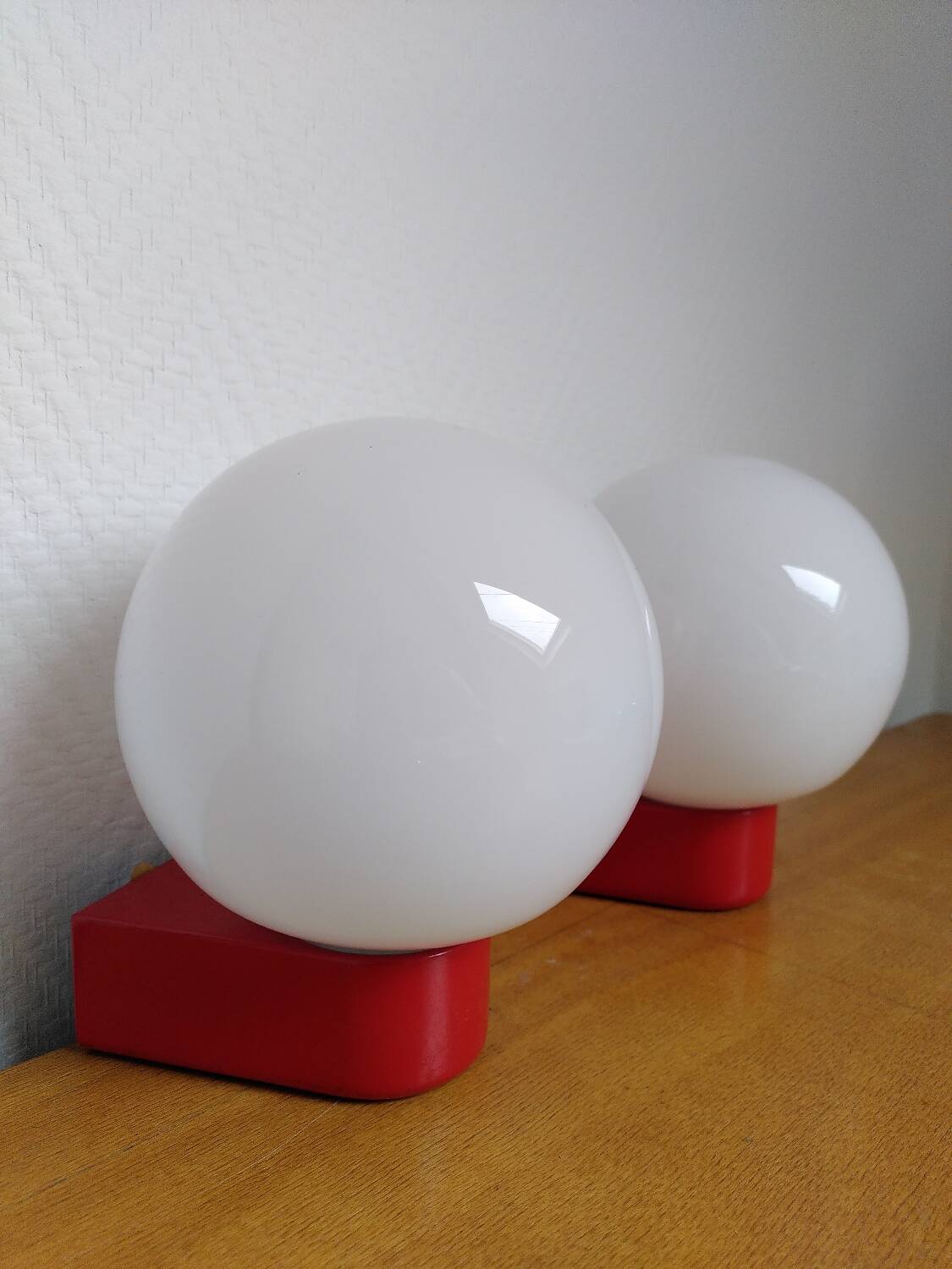 2 postmodern opaline and red metal wall lights, 1980
