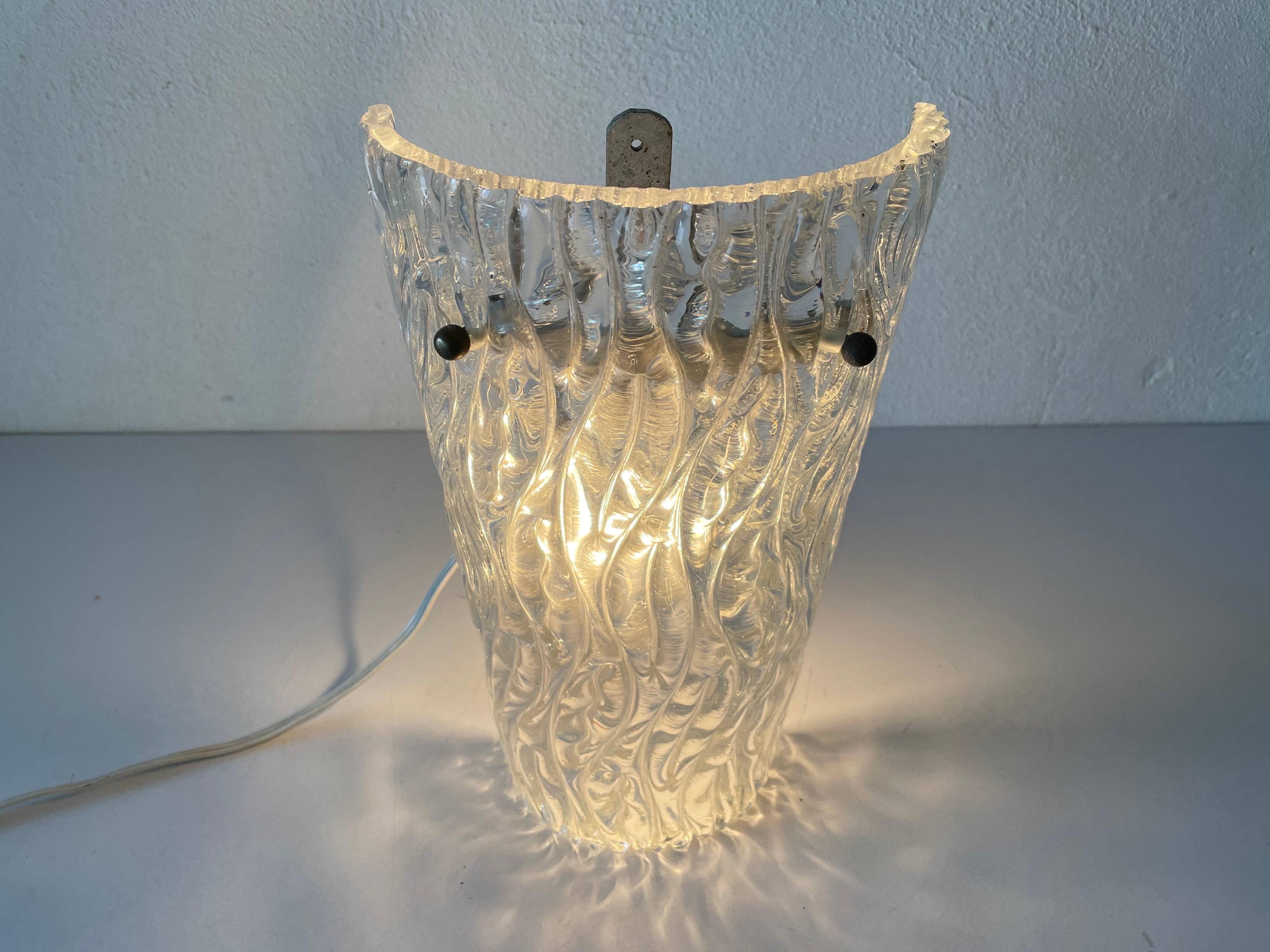 Simple arch-shaped wall light in textured glass, 1950s, Germany.