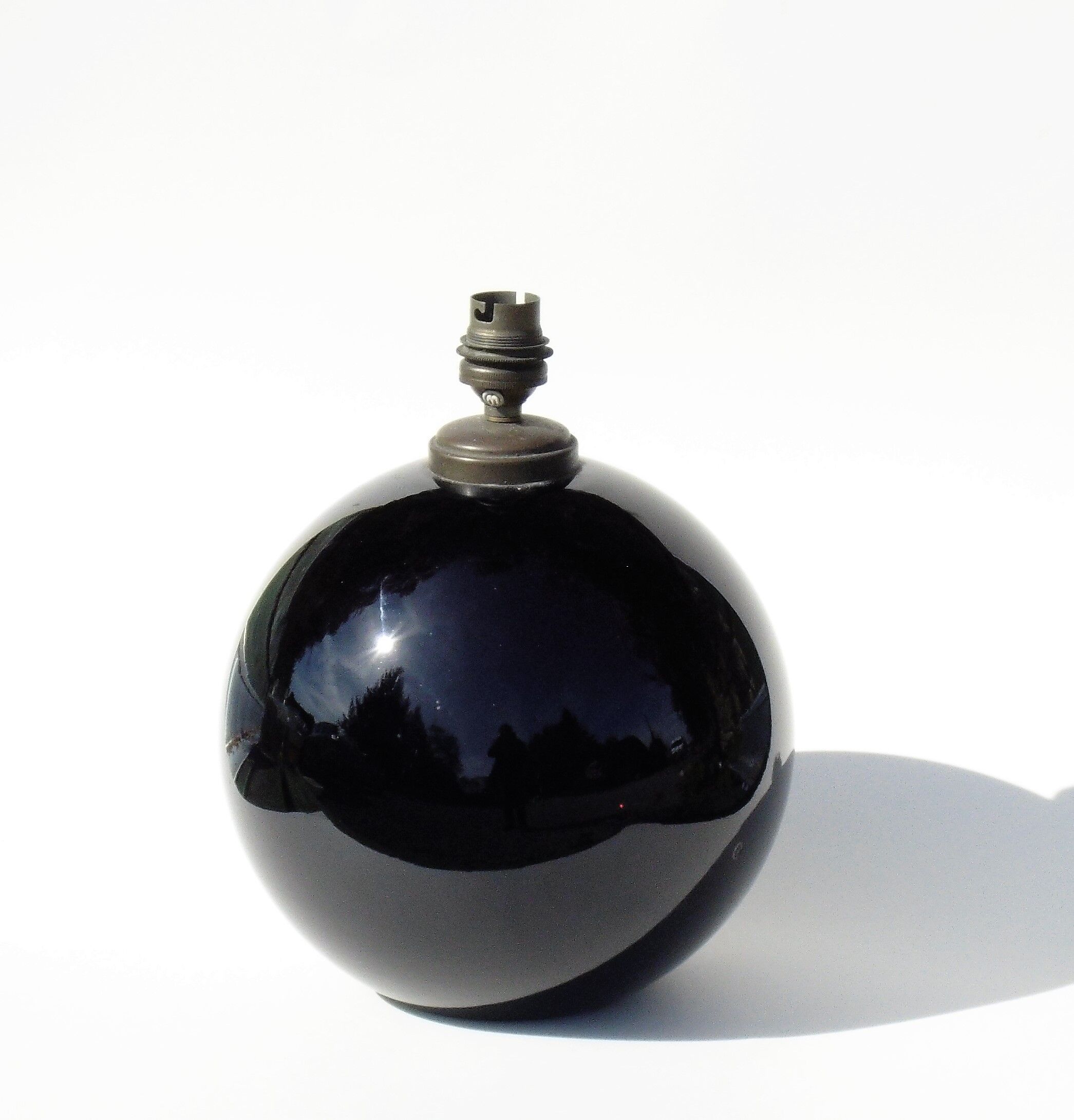 Old lamp foot shaped ball in black glass