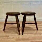 A pair of tripod stools from the period.