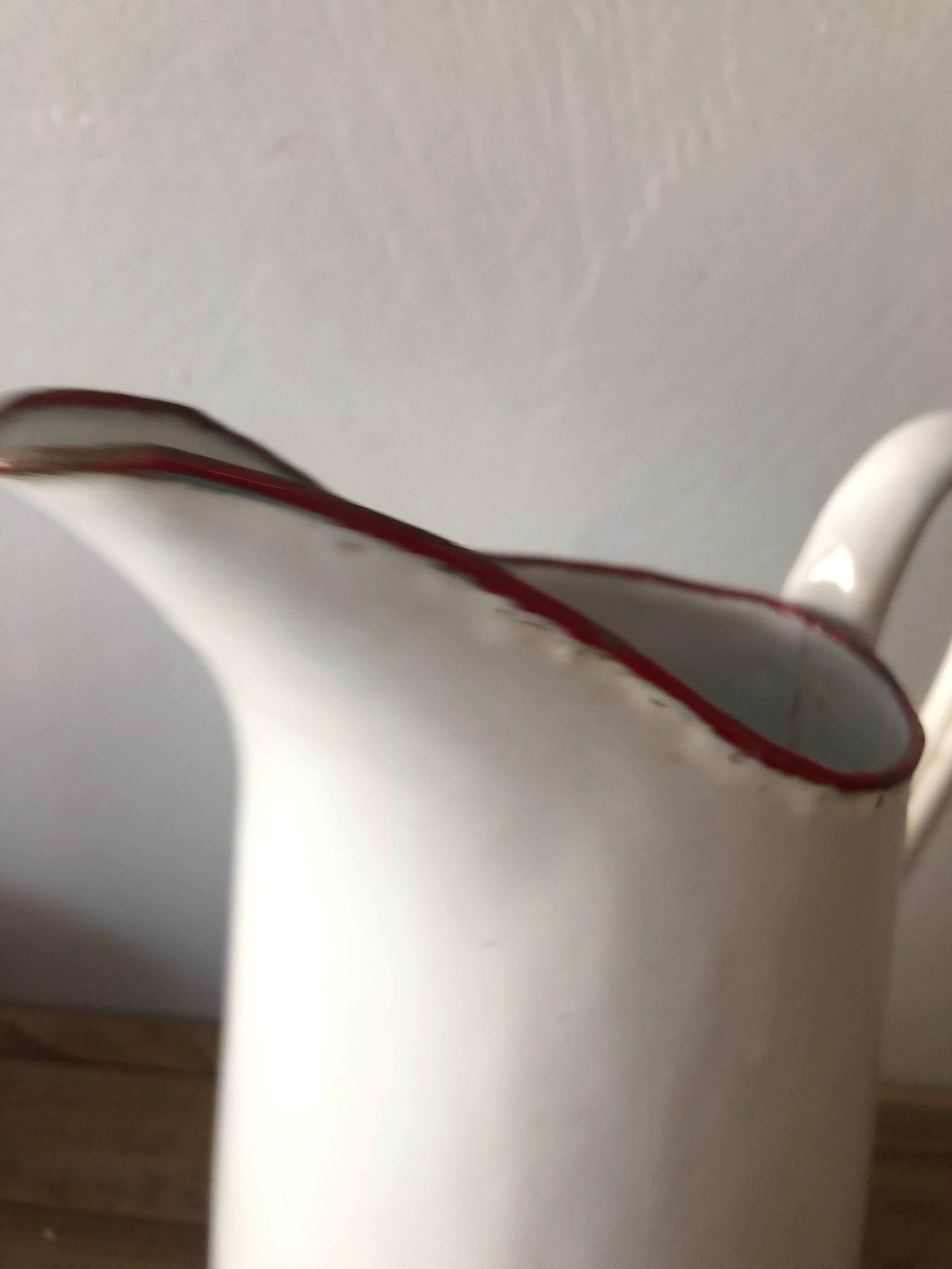 Old pitcher in enamelled sheet metal