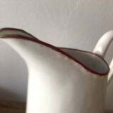 Old pitcher in enamelled sheet metal