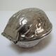 silver metal nutcracker in the shape of vintage walnuts