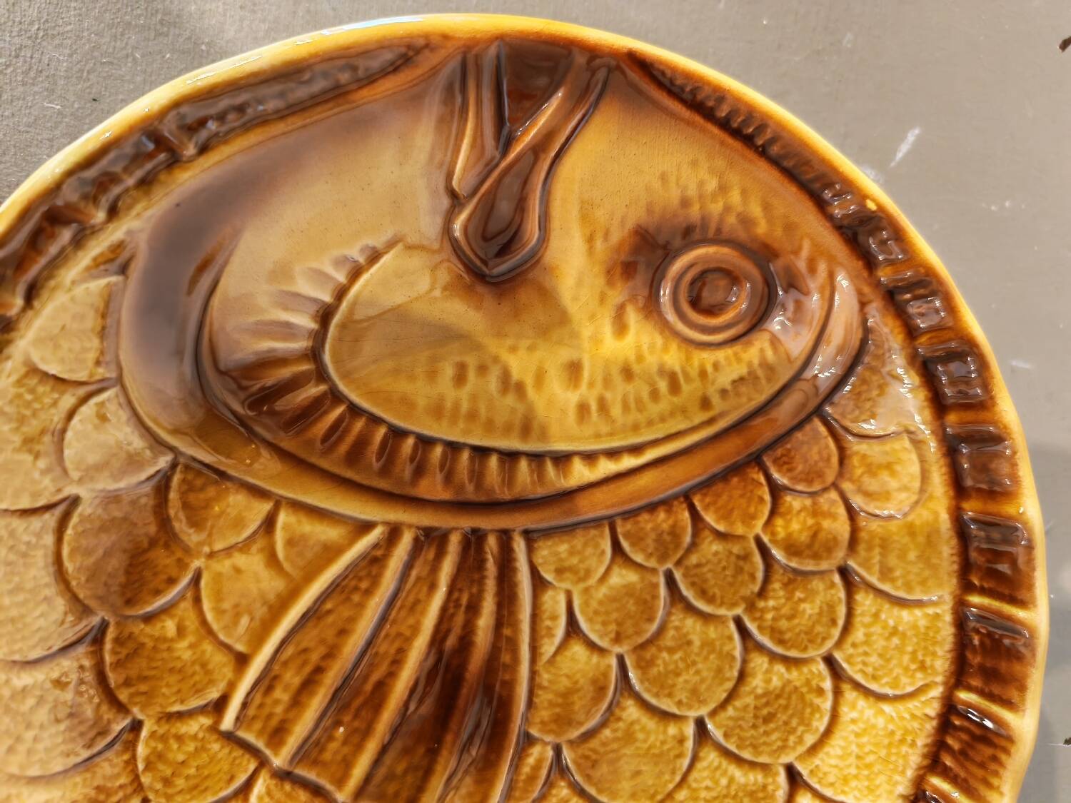 Vintage barbotine plates with fish decoration, 22 pieces.