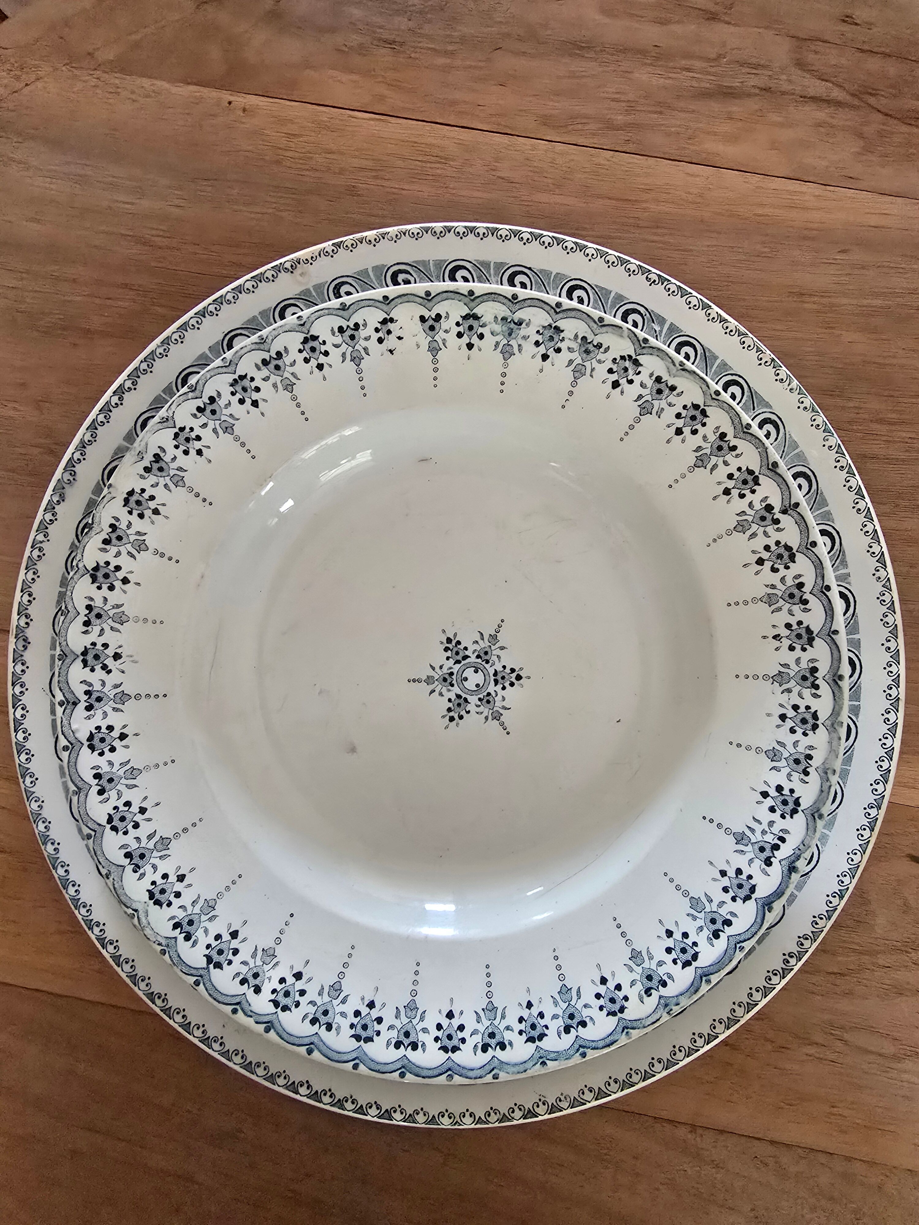 Old green-blue faience plates and dishes with geometric patterns.