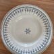 Old green-blue faience plates and dishes with geometric patterns.