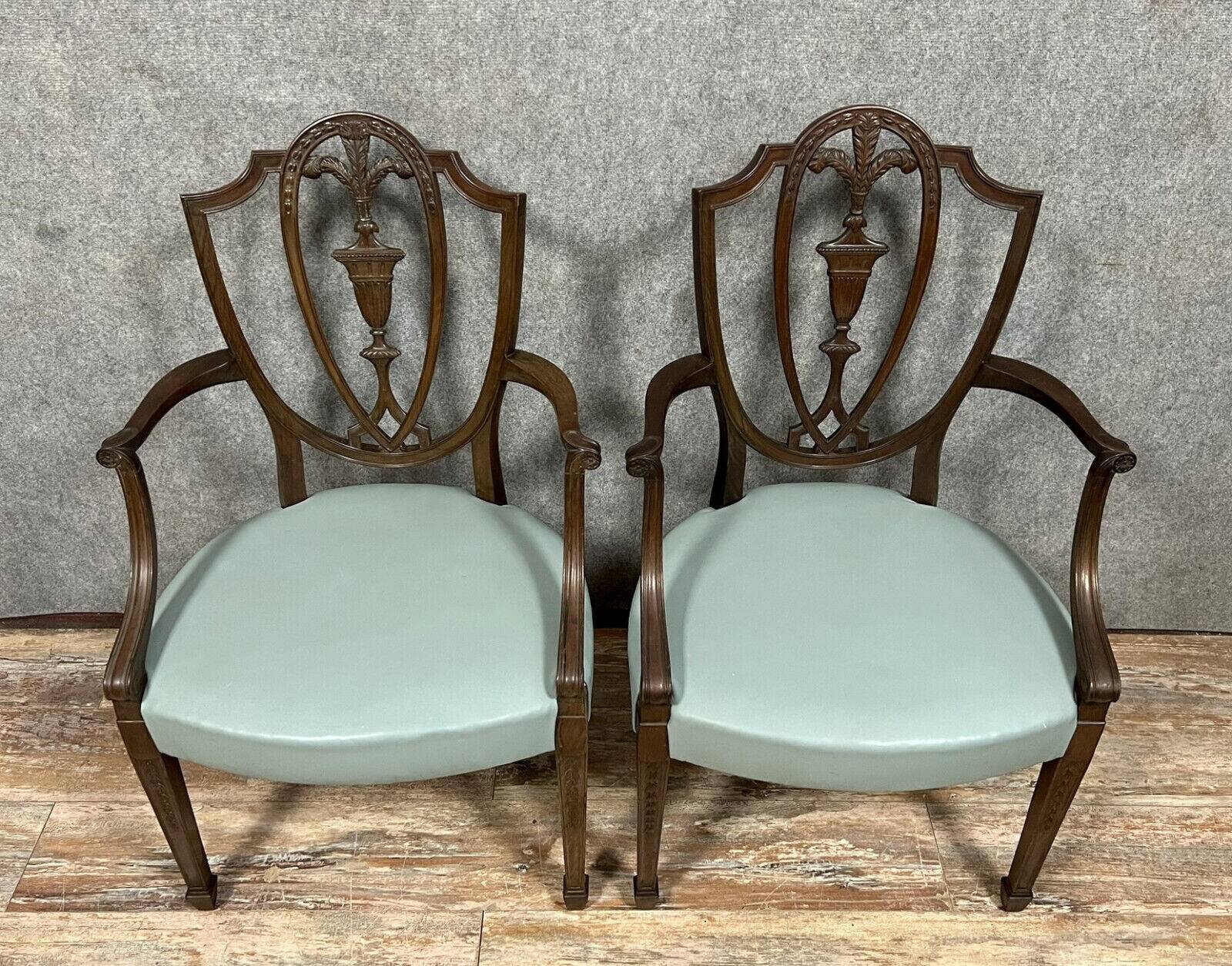 According to George Hepplewhite: pair of 19th century mahogany office armchairs