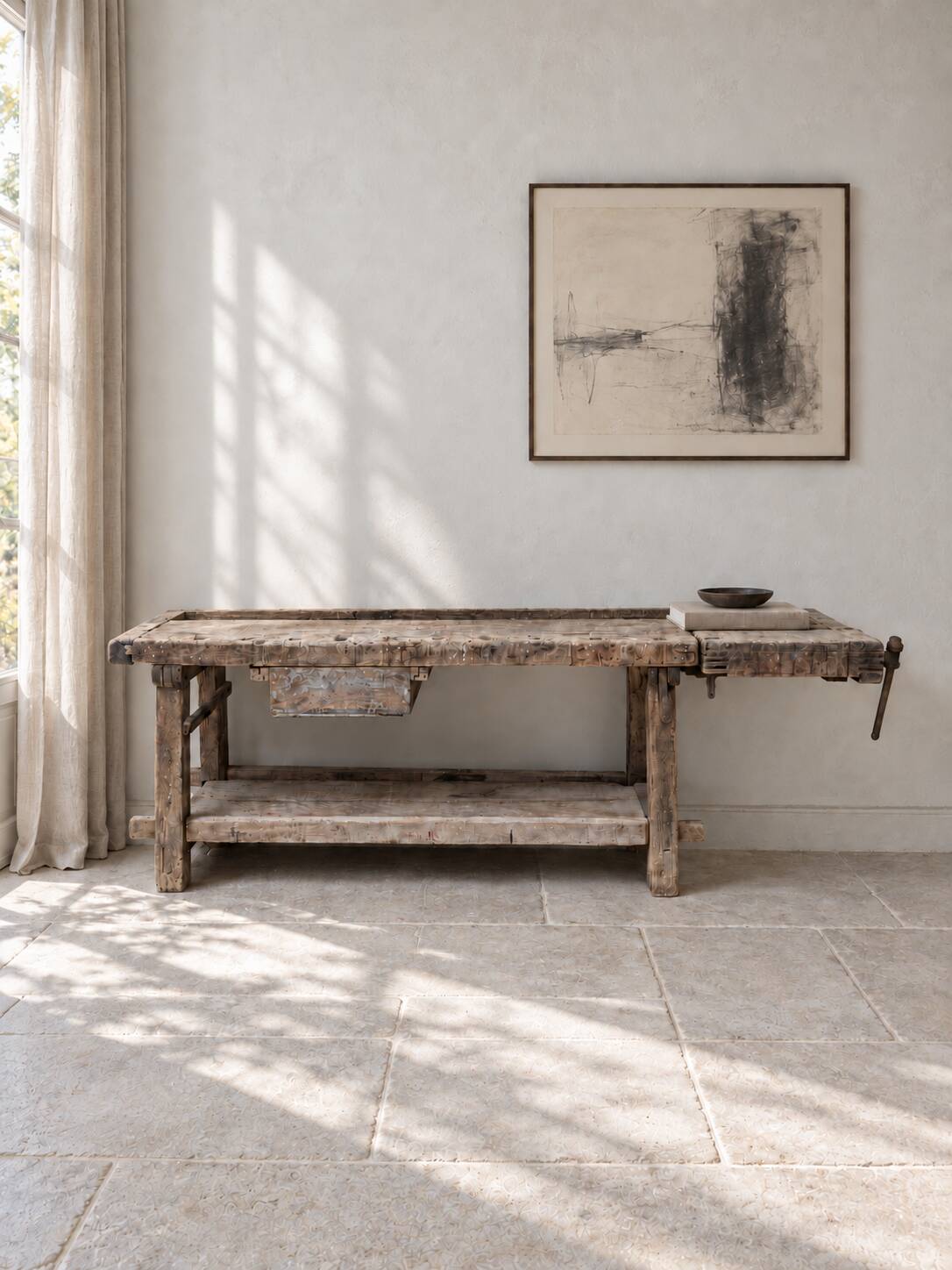 Antique wooden workbench with a vice and drawer.
