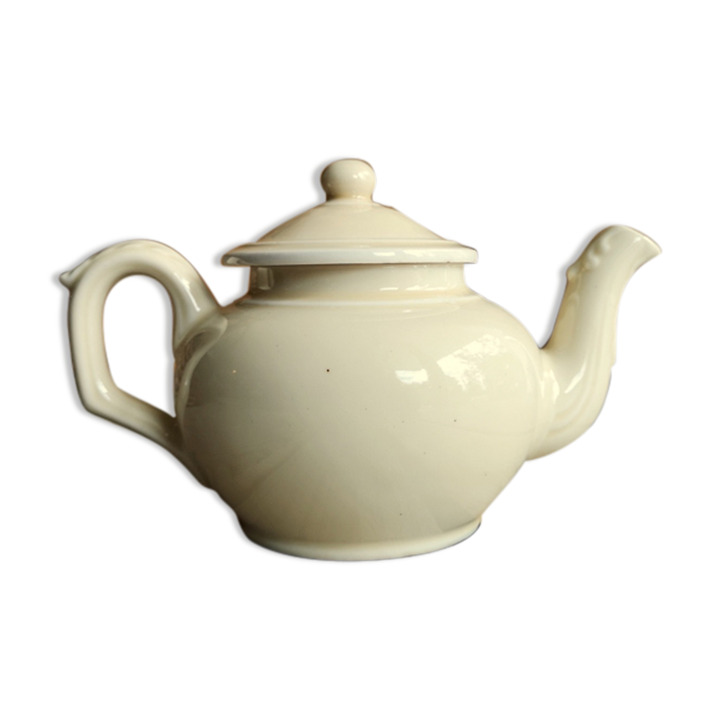 Little ancient teapot in ceramics color cream