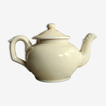 Little ancient teapot in ceramics color cream