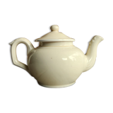 Little ancient teapot in ceramics color cream