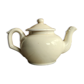 Little ancient teapot in ceramics color cream