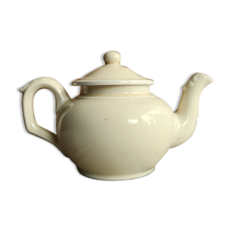 Little ancient teapot in ceramics color cream