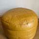 2 poufs moutarde patchwork en cuir de Sède