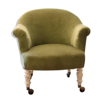 Toad in almond green velvet armchair on castors