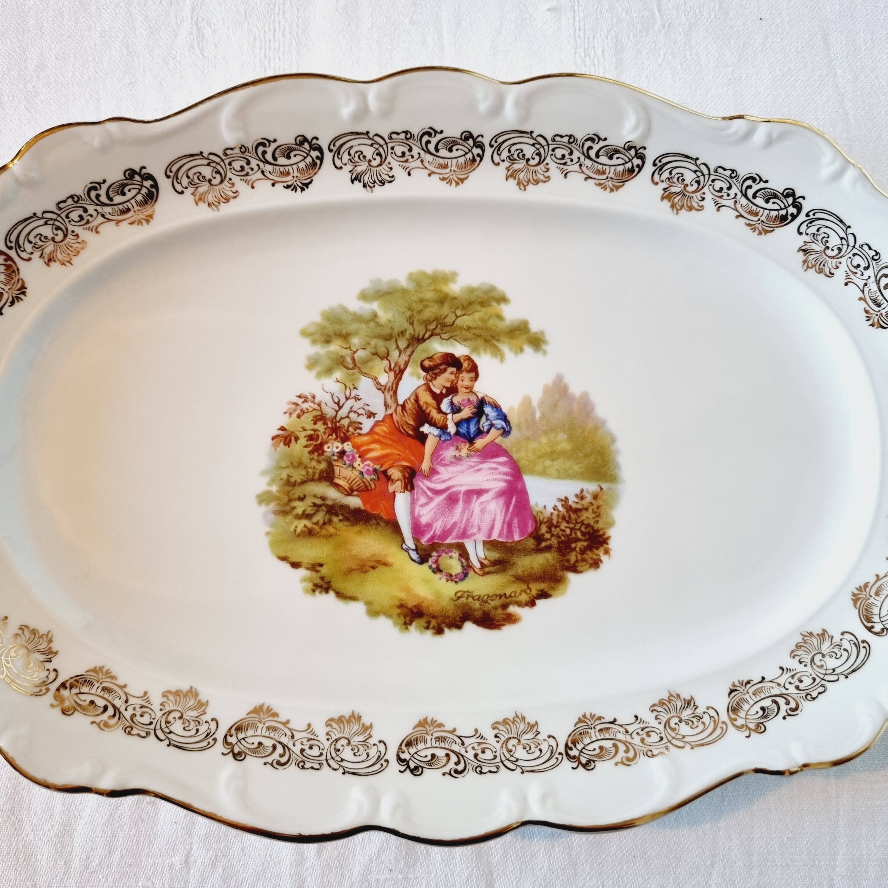 3 serving dishes with frangonard romantic scene with designs and borders in 24 carat gold.