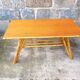 Rattan coffee table with compass legs