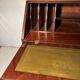 Antique mahogany secretary, upholstered flap and interior storage