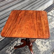 19th-century solid mahogany table with a tilting top and brass mechanism.