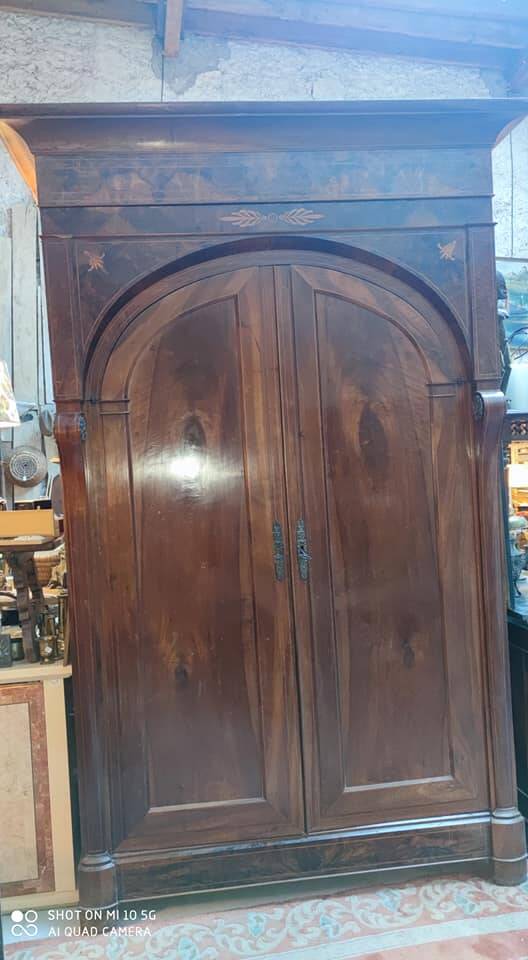A walnut wardrobe with marquetry and boxwood stringing, dating from the Consulate period, circa 1810.