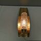 Older wall lamp in brass with hard pressed glass shade.