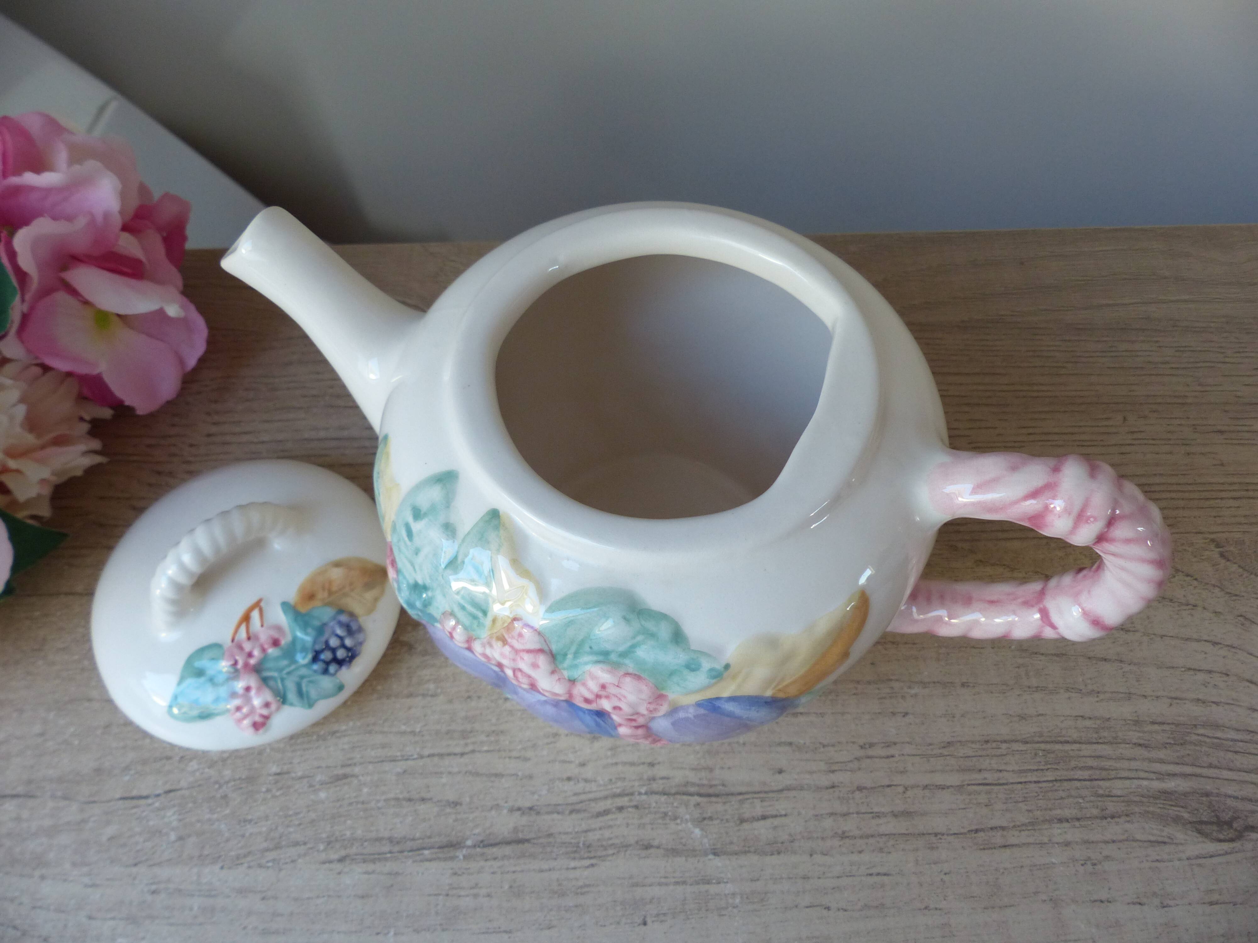 Old ceramic teapot in the shape of a basket of fruits from the garden