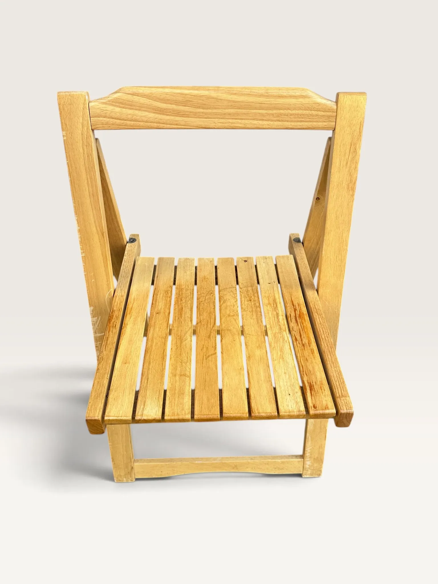 Blonde wooden folding chair in the style of Aldo Jacober.