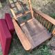 Morris chair with wooden frame and burgundy cushions.