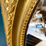 Mirror XIXth medallion on gilded frame with leaf