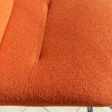The 1970s orange armchair fabric and chrome metal