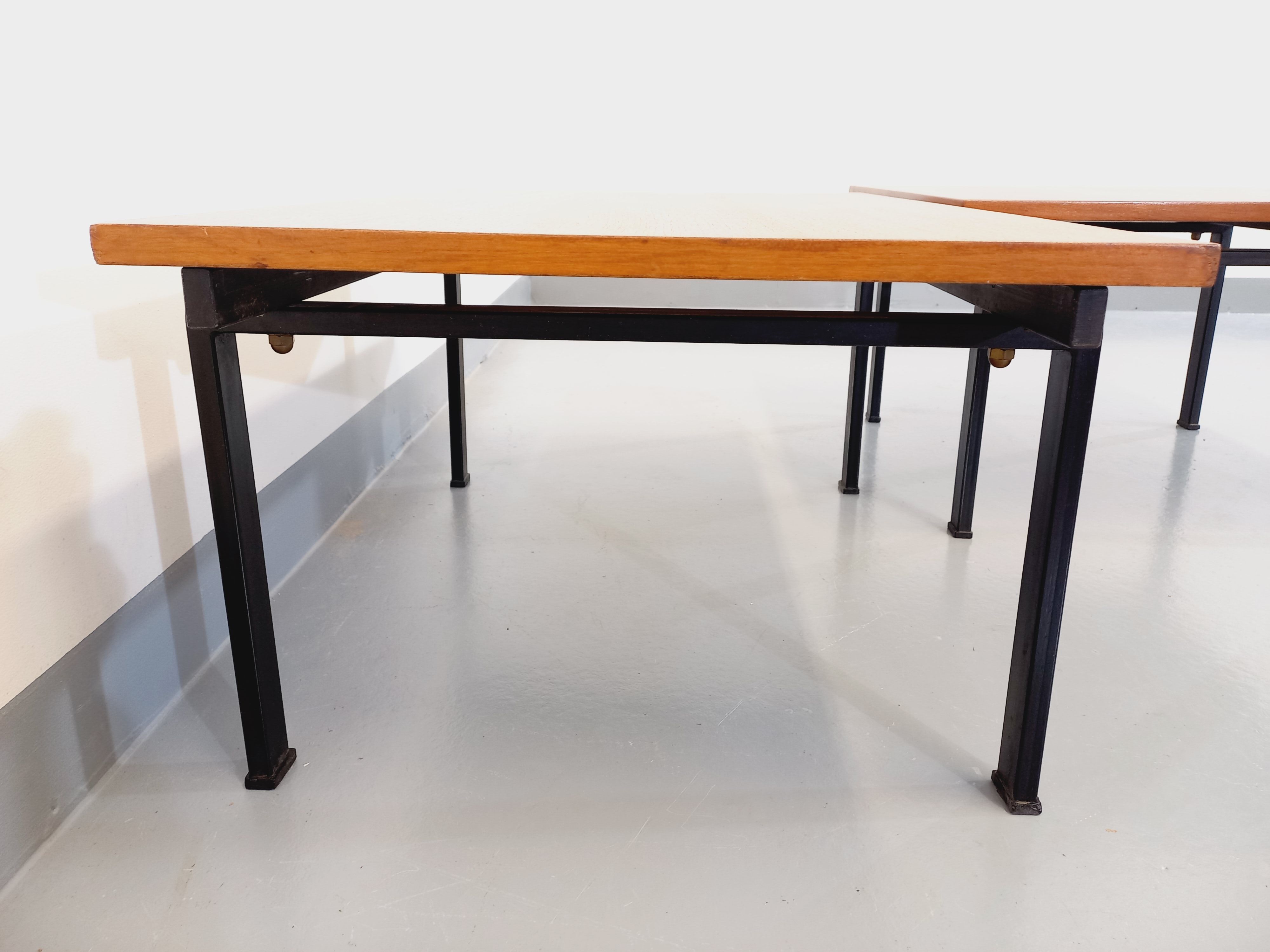 Suite of two vintage modernist Isa coffee tables in teak and black metal from the 60s