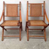 Pair of folding chairs in bamboo and caning, leather and brass