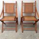 Pair of folding chairs in bamboo and caning, leather and brass