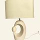 Cream ceramic table lamp with a mid-century design, featuring a lampshade.