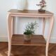 Side table with curved pink legs