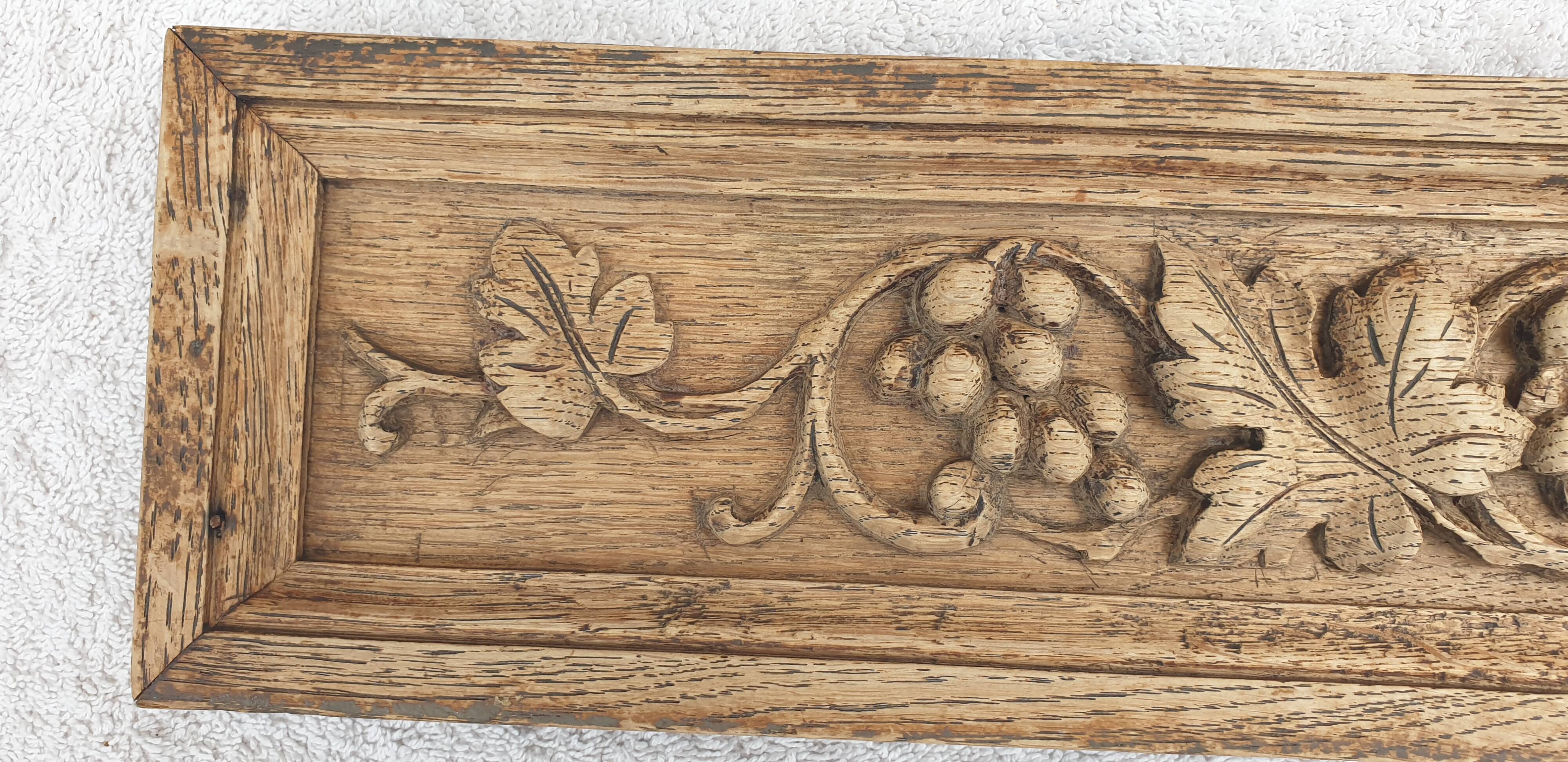 Natural wood pediment with bunches of grapes