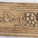 Natural wood pediment with bunches of grapes